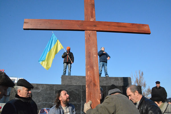 十字架を建てる人々。ウクライナ国旗を持つ少年がいる場所にレーニン像がそびえていた。＝9日、ドネツク州マリウポリ　写真：筆者＝