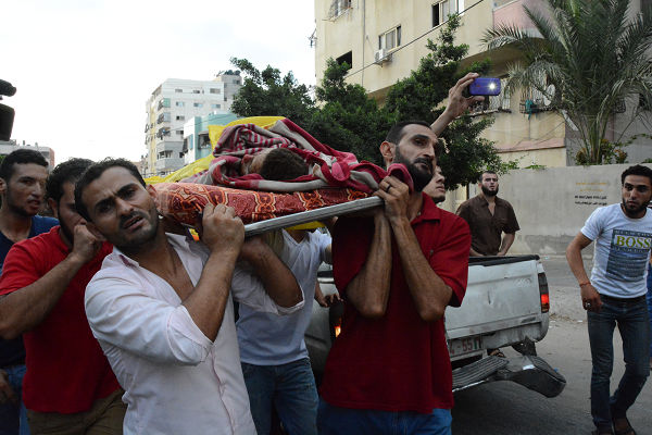 ドローンによって殺害された子供の遺体をモスクに搬送するパレスチナの人々。この間もドローンは不気味な音をたてて上空を舞っていた。=2014年7月、ガザ　撮影：筆者=