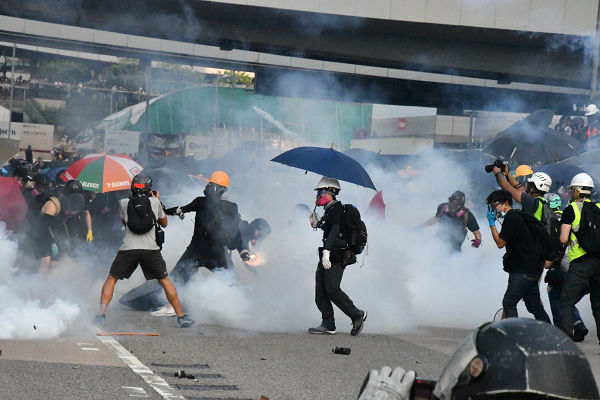 人民解放軍基地前と政府本部庁舎前で催涙弾と火炎ビンが飛び交う。それが香港の現実だ。＝15日、金鐘　撮影：田中龍作＝