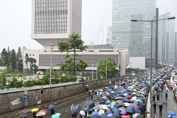 中国人民解放軍・駐香港基地前をデモ行進する人々の列は、長江のごとく続いた。シュプレヒコールは「香港反抗」だ。＝6日、アドミラルティ　撮影：田中龍作＝